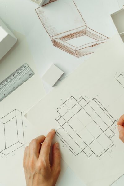 The designer draws a sketch of the package. Creating a cardboard eco box for the delivery of goods.